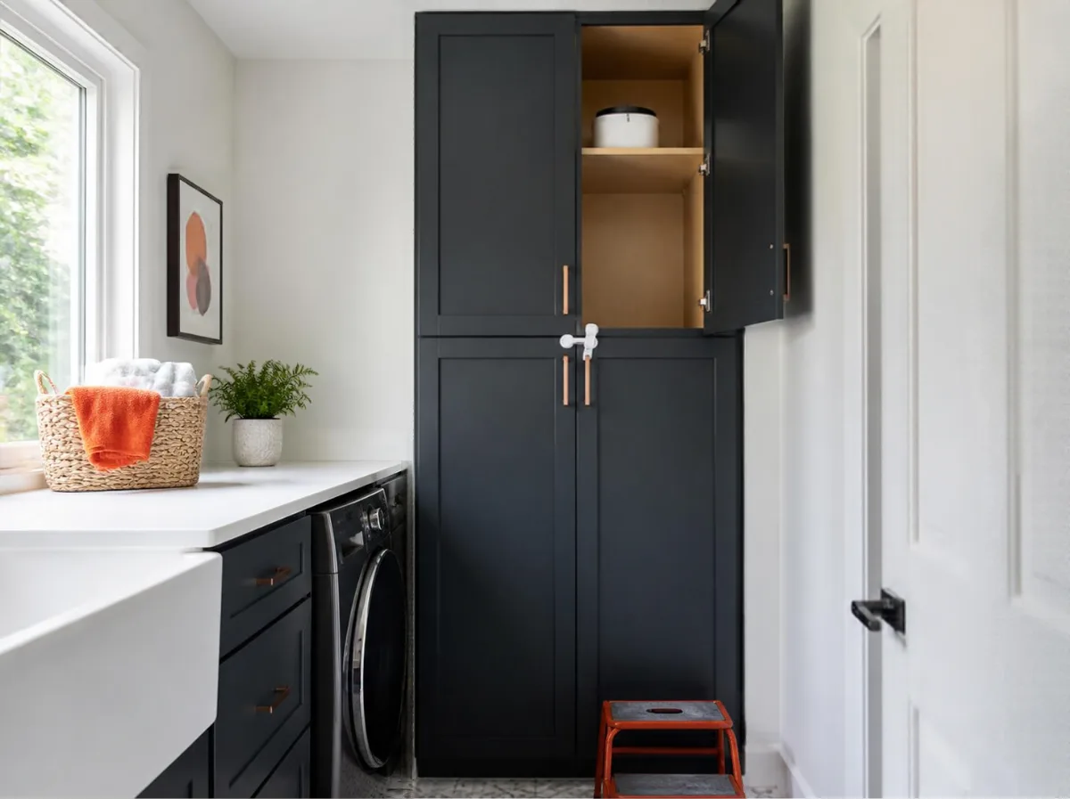 Tall laundry room cabinet with a latch, keeping detergent pods on a high shelf away from children